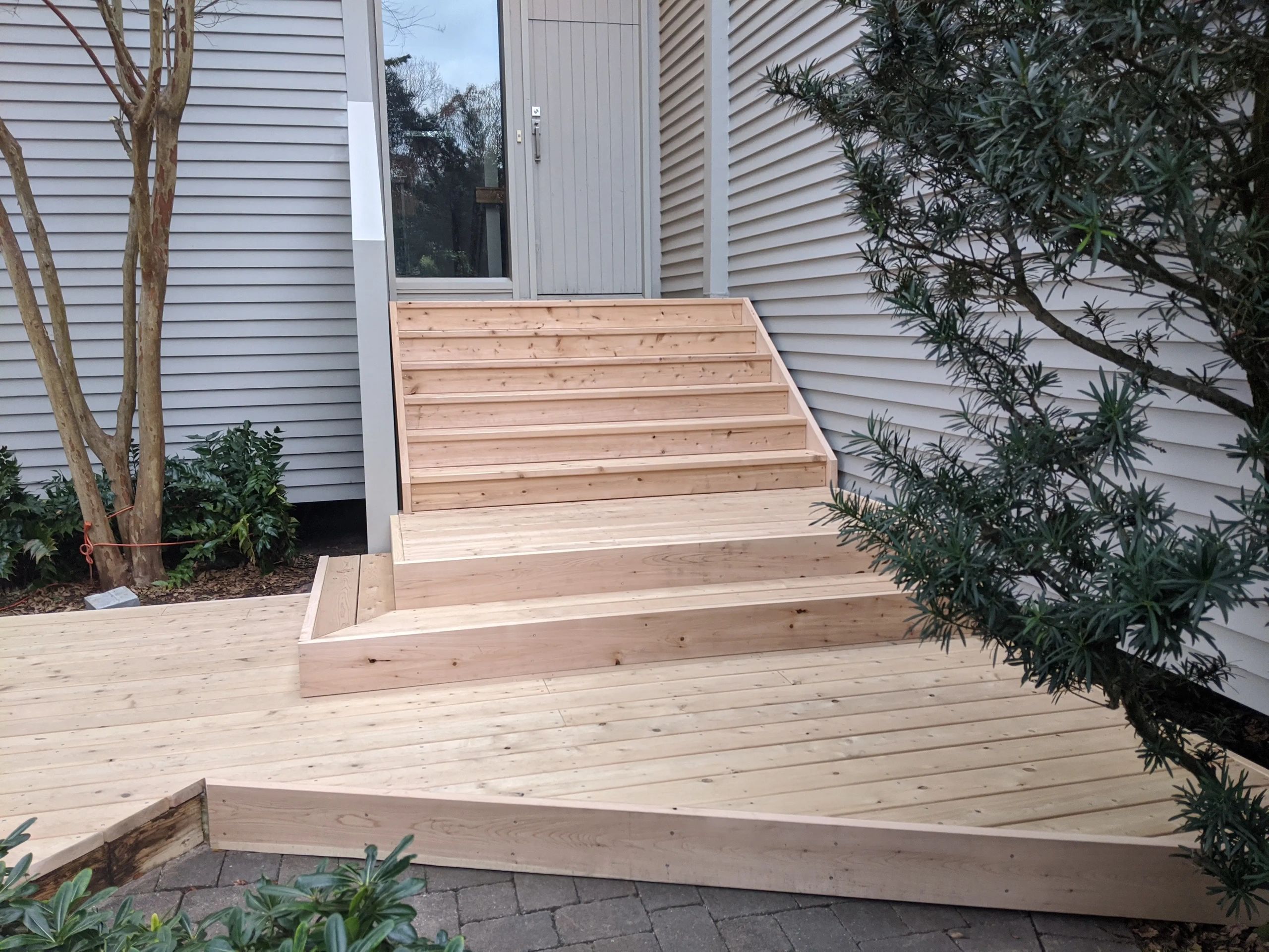 White cedar decking with layered stairs.