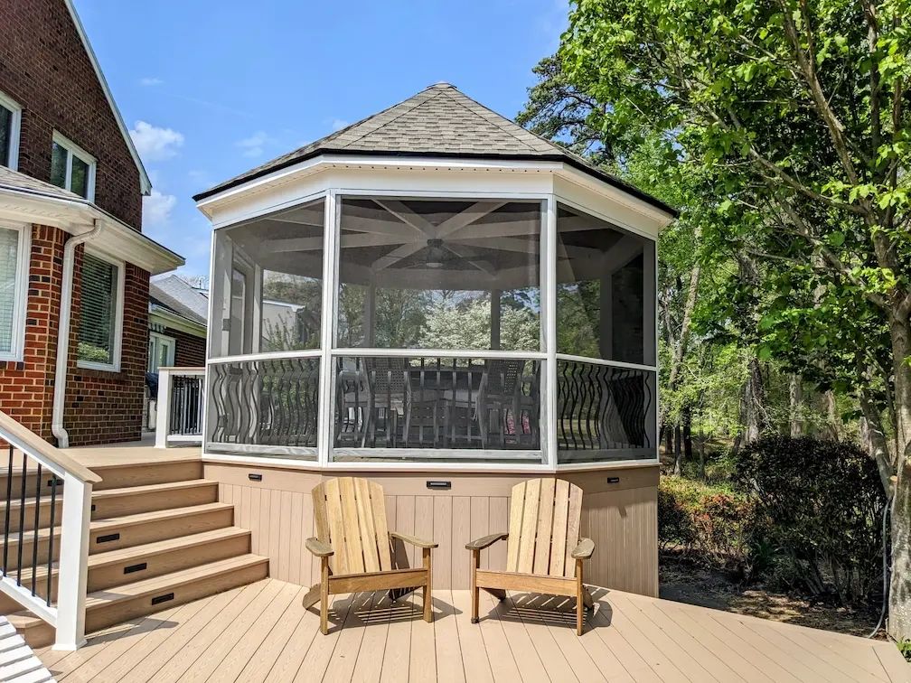 Chairs in front of the gazebo with custom railings, pvc skirt and accent lighting.