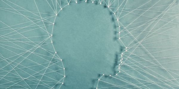 A profile view of a head created by an outline of pegs and strings connected together