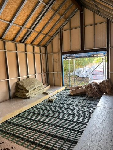Interior of a building under construction with insulation materials.