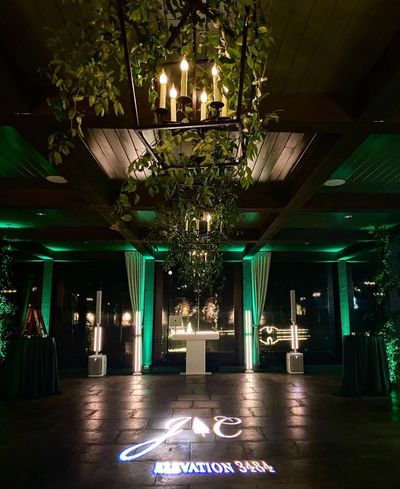 Moody green uplighting for a holiday wedding