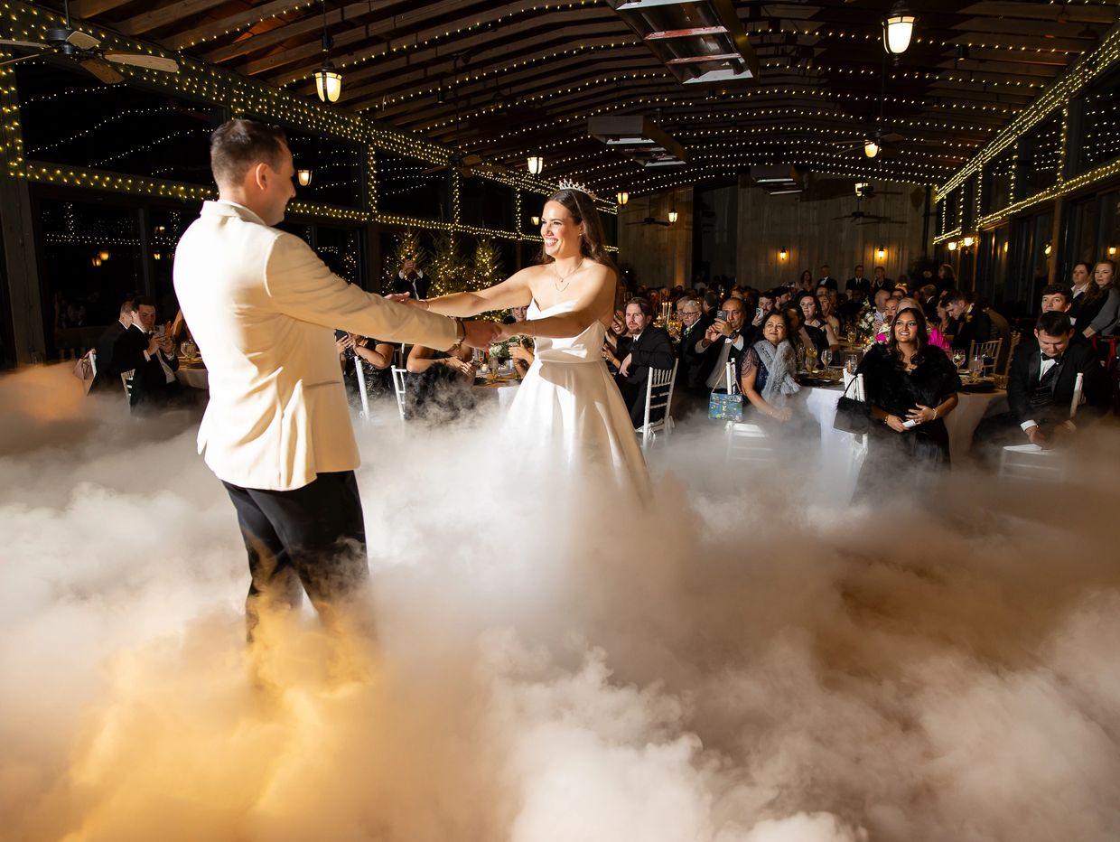 Newly weds dancing on the clouds at their asheville wedding