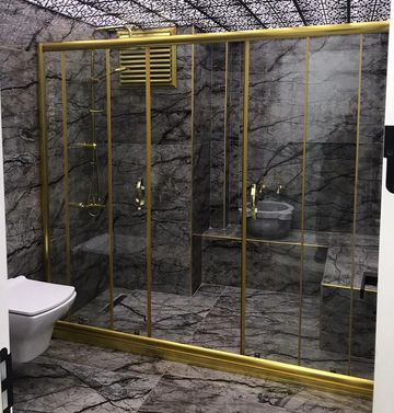 Luxurious bathroom with gold-framed glass shower and marble walls.