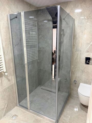 Modern glass shower enclosure in a sleek bathroom.