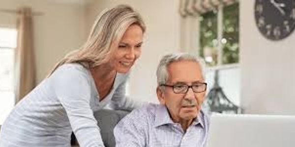 Senior man and woman using a laptop together at home.