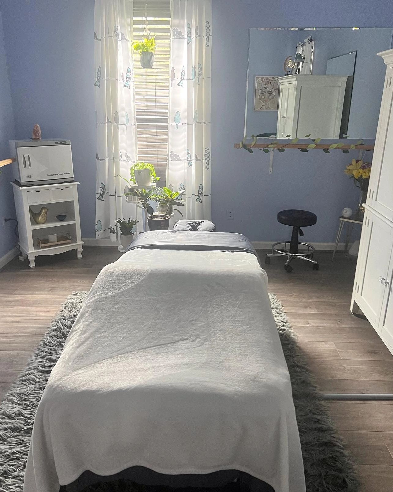 Daytime. Relaxing, light and airy Massage Room with Salt Lamp and Candles.