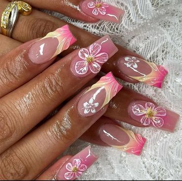 A woman lifting her hand to show off her stylish nail design.