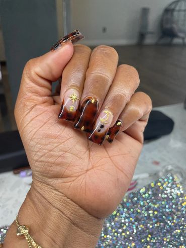 Woman gently curling her fingers to display her painted nails.