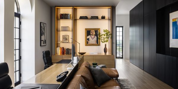 Modern, black floor to ceiling cabinetry with a custom built in cabinet.
