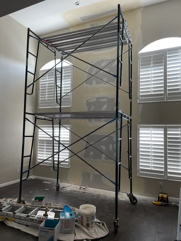 Fireplace removal drywall work with scaffolding tower