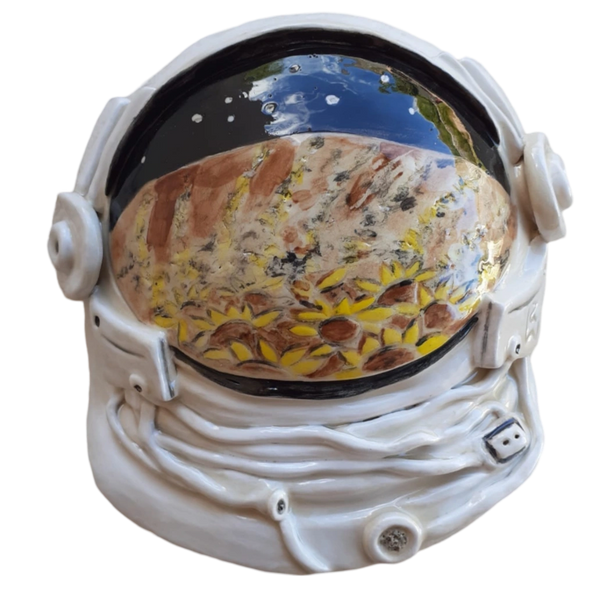 Sculpture of space helmet with reflection of sunflowers.