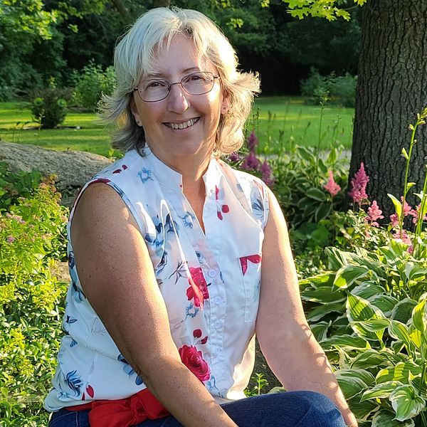 Artist Ann Lauwers sitting in her garden.