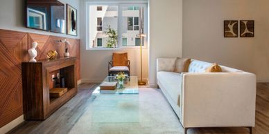 Modern living room with a white sofa and wooden accents.
