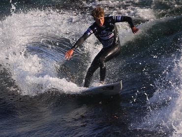 A surfer in a black wetsuit competes at the Coldwater Classic Surf Contents at Steamers Lane