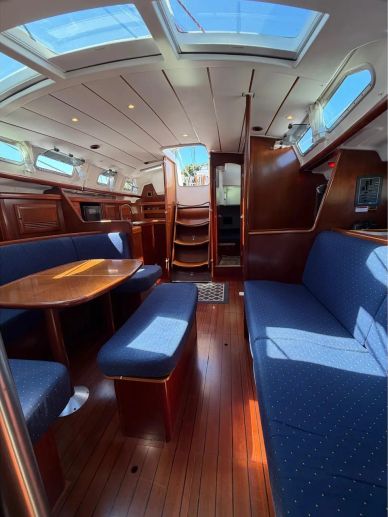 Cozy yacht interior with blue upholstery and wooden finishes.