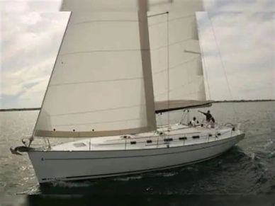 White sailboat sailing on calm water under cloudy sky.