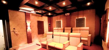 Cozy home theater with leather recliners and warm lighting.