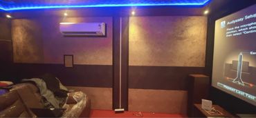 Cozy home theater setup with projector screen and leather seating.