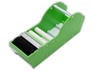 Green handheld cigarette rolling machine with white rollers.