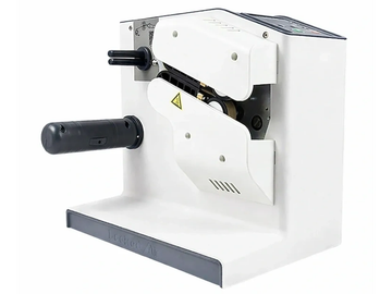A compact white machine with a black handle and warning label.