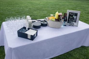 a small bar set up with juices and mixers