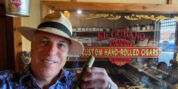 manny in front glass window of a humidor