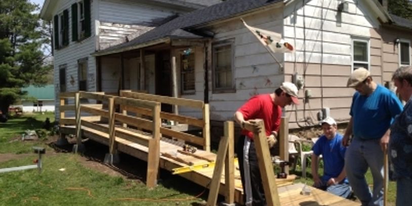 group of people building a ramp at a house