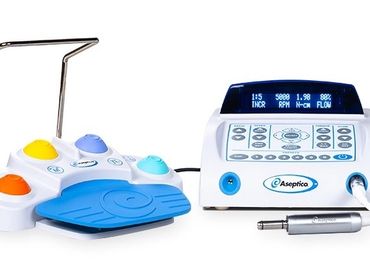 A white and blue Aseptica medical device with colorful foot pedals and digital display.