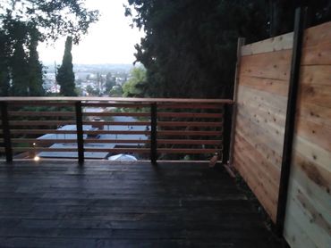 custom deck build with a view, bar counter top railings and a privacy wall