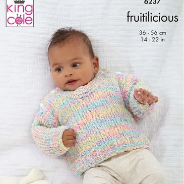 A baby wearing a sweater knit out of Fruitilicious yarn from King Cole.