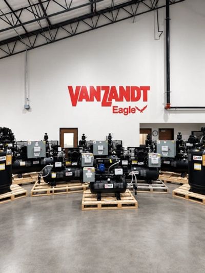 Industrial equipment in warehouse with Vanzandt Eagle logo.