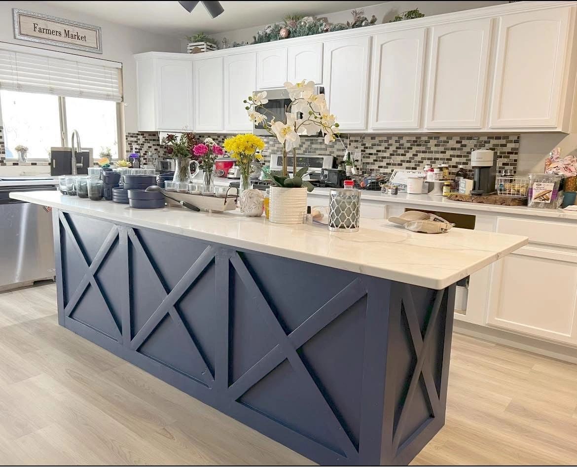 Stack of books next to pencils in a holder and a camera.