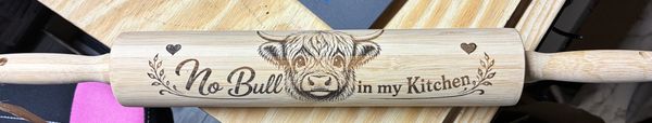 Wooden rolling pin with "No Bull in my Kitchen" and a bull illustration.