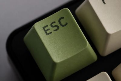 Close-up of a green ESC key on a keyboard.
