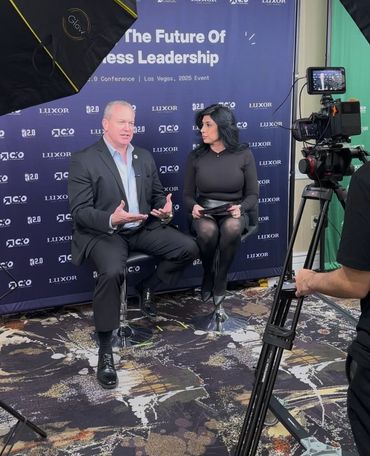 Two professionals being interviewed at a leadership conference.