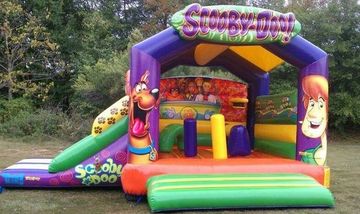 Scooby-Doo bounce house combo. Slide, pop-ups, and arch perfect interactive inflatable for toddlers.