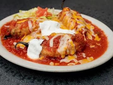 Chili relleno dish with cheese and sour cream.
