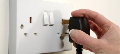 close up of plug being inserted into a socket