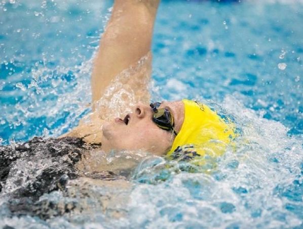 Woman taking swimming leasons.