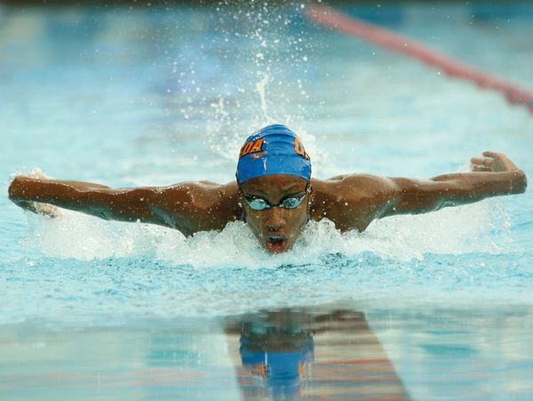 Man swimming at a competition.