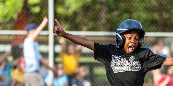 Young baseball player celebrates homerun