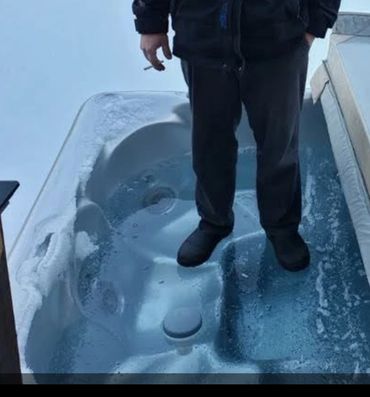 Owner standing on his frozen hot tub