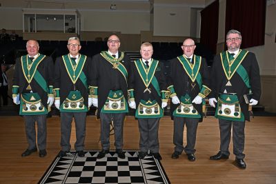Group of six men in Masonic regalia standing on a checkered floor.