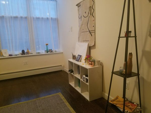 Different perspective of the interior living room with re-organized, warm, colorful aesthetic.