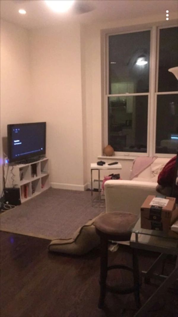 Living room with bare decor and light clutter.