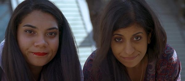 Two women stare unhappily into the camera.