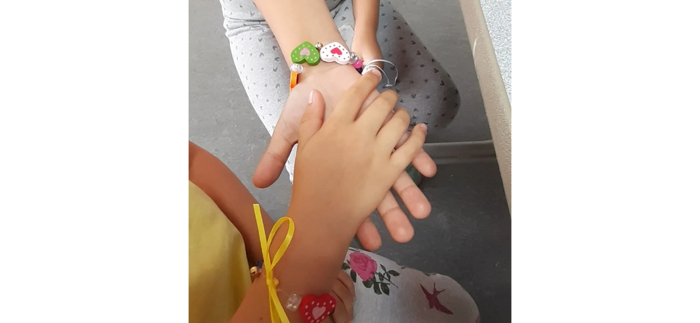 Children wearing the bracelets they made on our Children's Arts and Yoga Summer Club 2021
