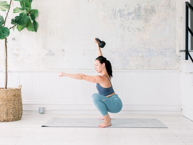 Demonstrating a kettlebell exercise