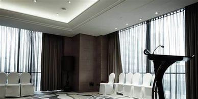 Motorized Drapery in windows of Banquet Hall.  Commercial window treatments in Omaha & beyond