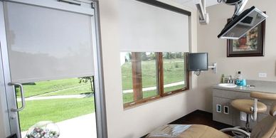 Motorized shades in windows of a dental office.  Commercial window treatments in Omaha & beyond